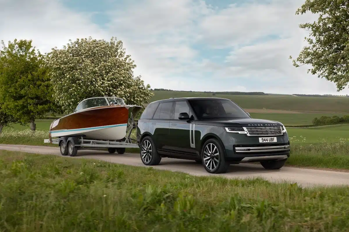 Range Rover Electric towing a boat on a trailer