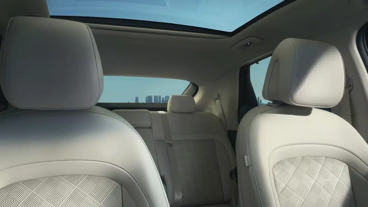 Light-colored Genesis GV60 seats and glass roof