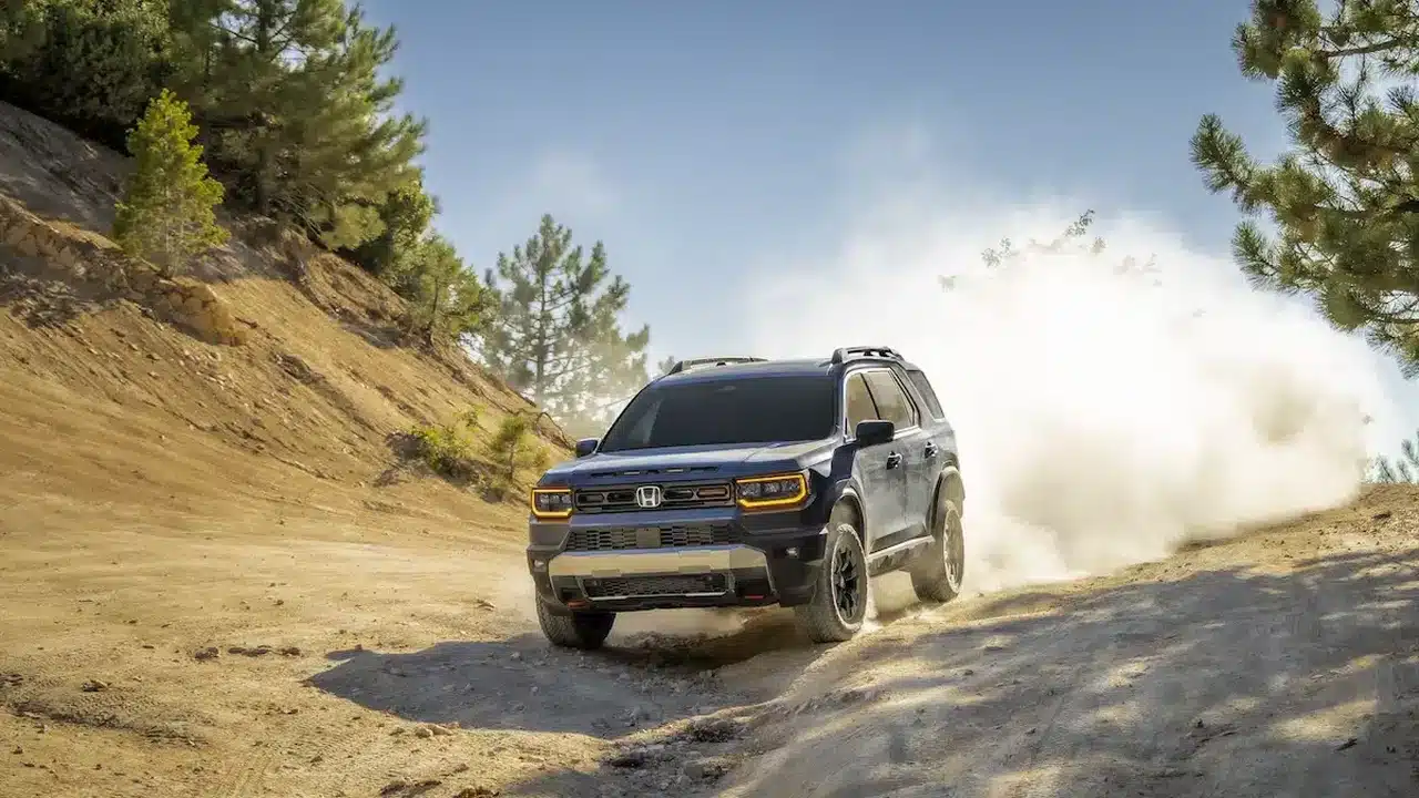 2027 Honda Passport TrailSport driving on a dusty trail
