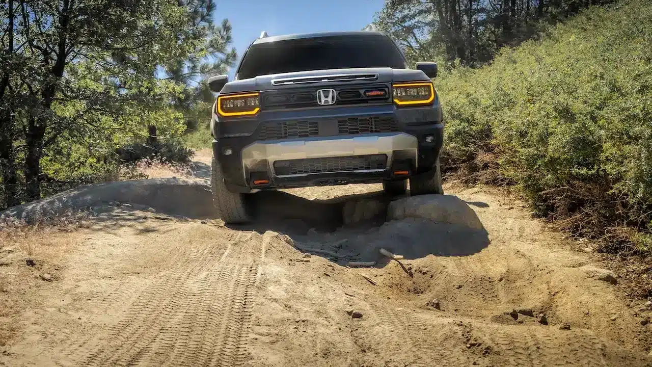 2027 Honda Passport TrailSport crossing a trail obstacle