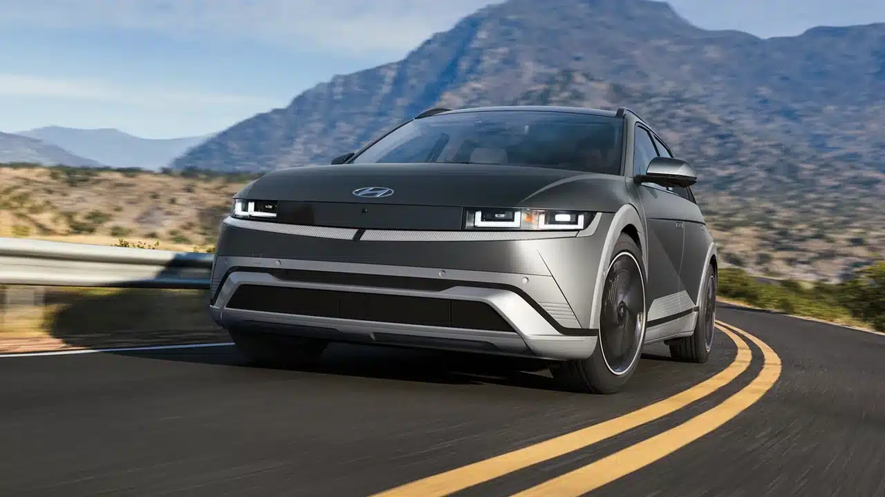 2027 Hyundai Ioniq 5 Limited driving around a mountain-road curve