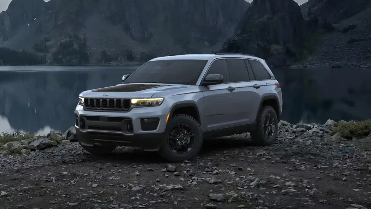 2027 Jeep Grand Cherokee Laredo Upland parked beside a lake