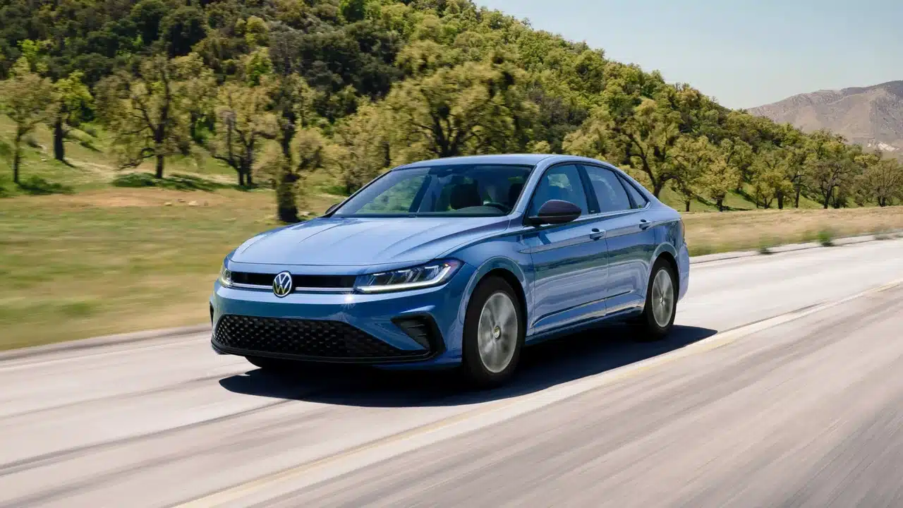 Blue 2027 Volkswagen Jetta driving on an open road
