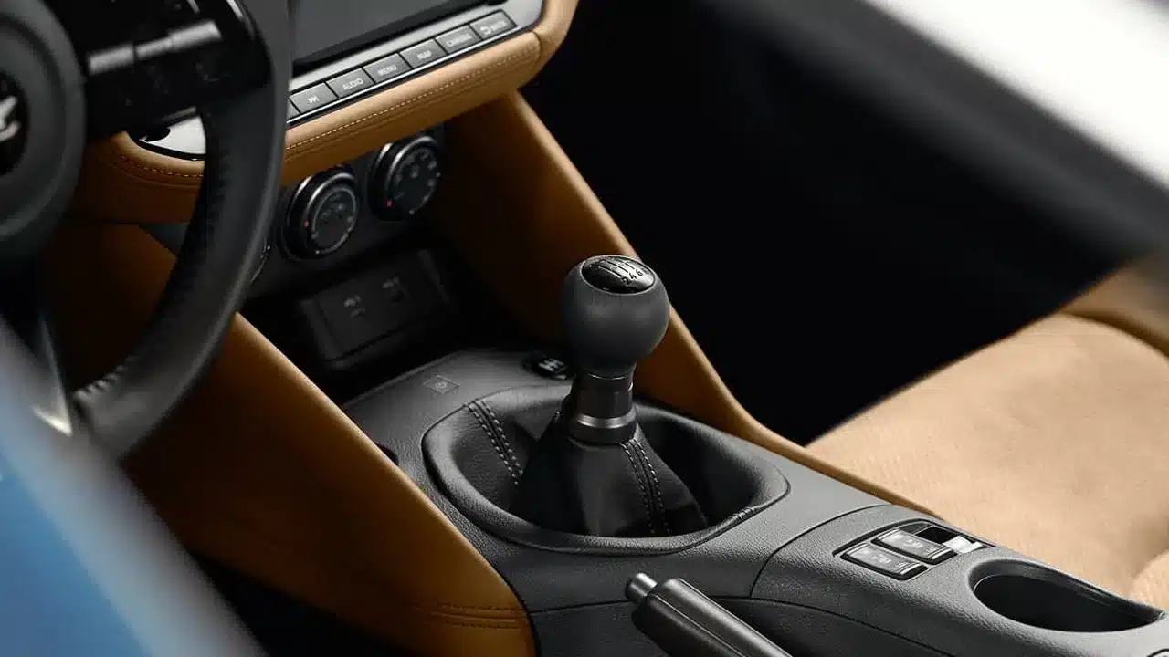 Six-speed manual shifter in a tan Nissan Z Performance interior