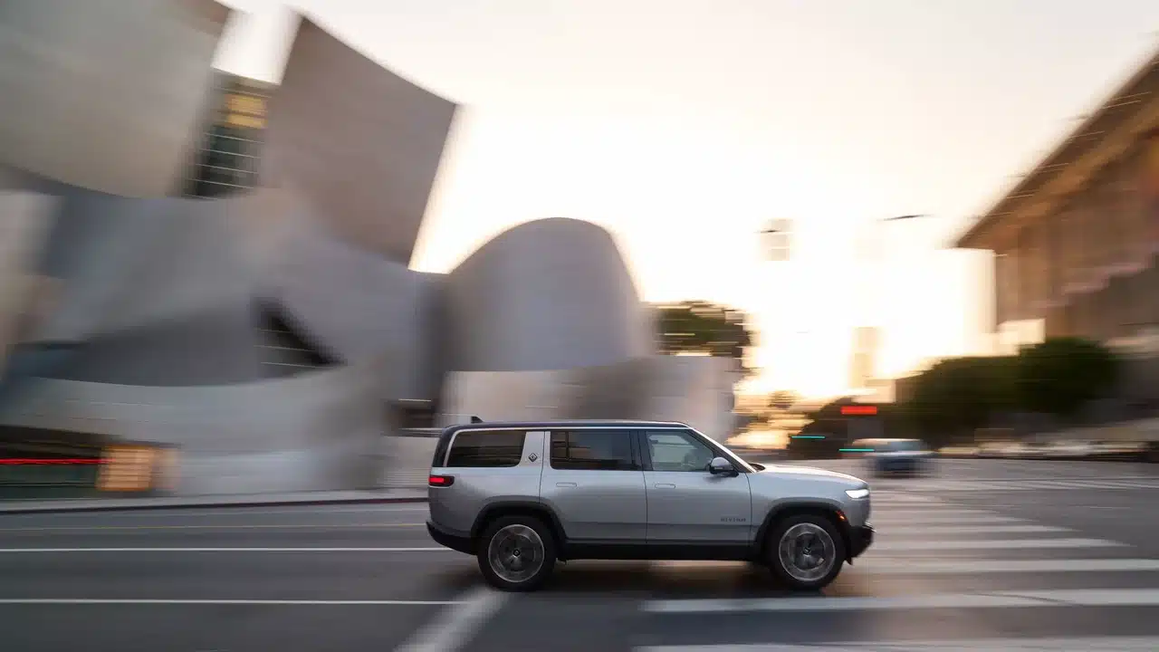 2027 Rivian R1S driving through a city