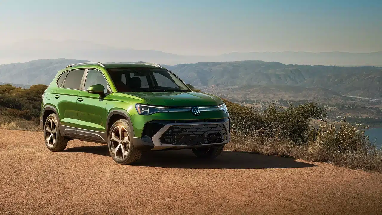 Green 2027 Volkswagen Taos parked with mountains behind it