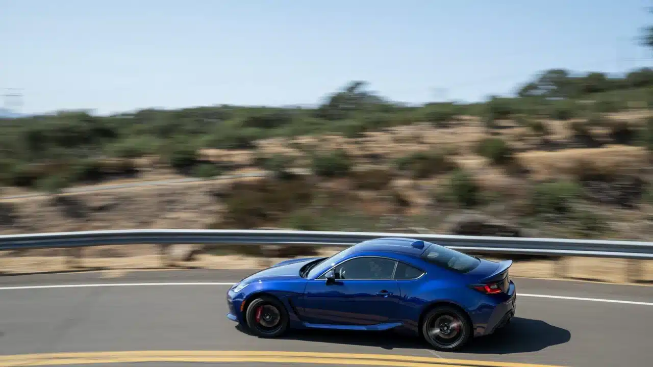 Blue 2027 Toyota GR86 driving on a winding road
