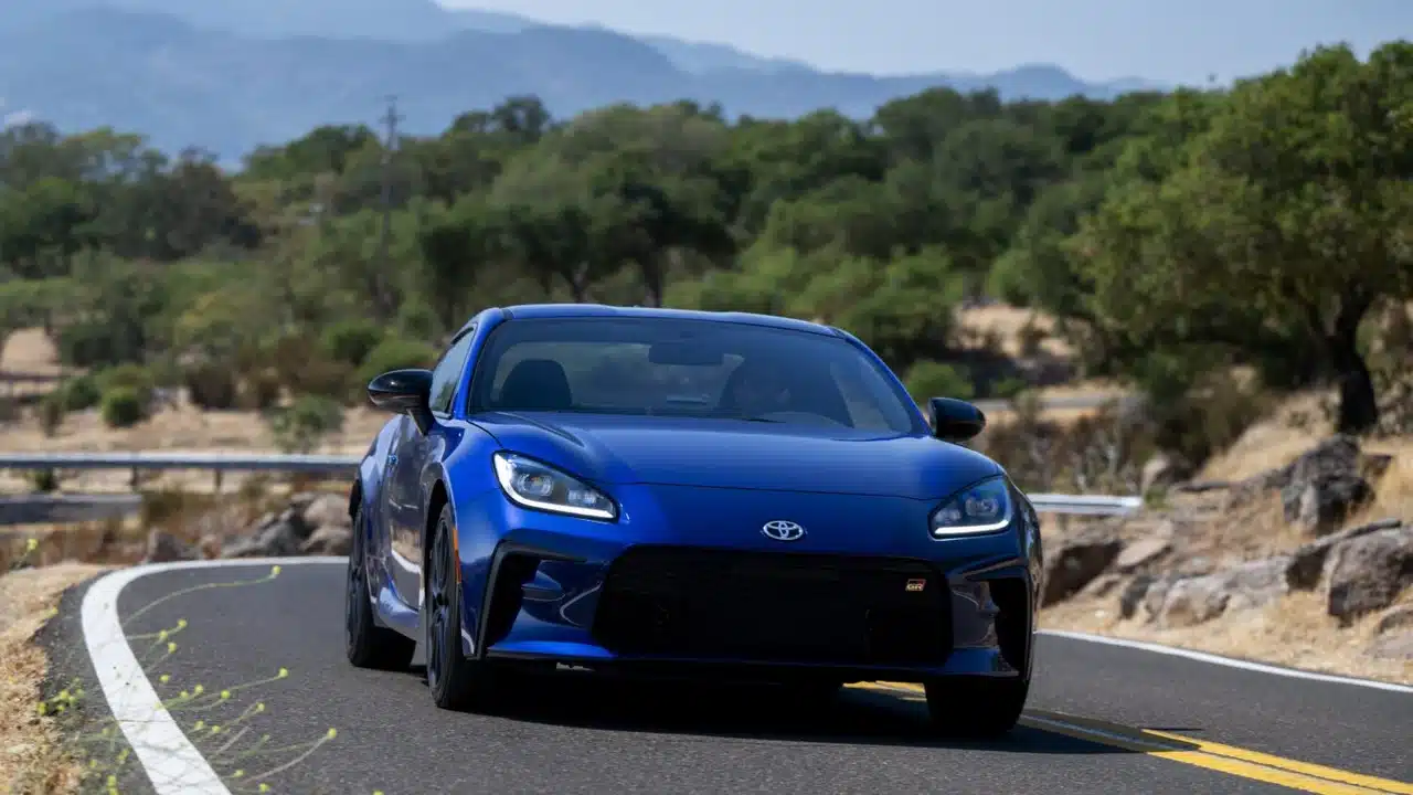 Blue 2027 Toyota GR86 rounding a bend