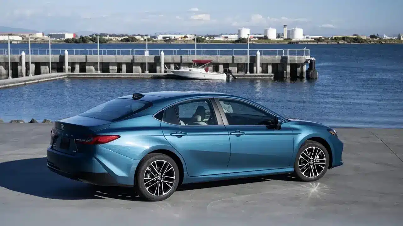 2026 Toyota Camry XLE viewed from the rear beside a waterfront