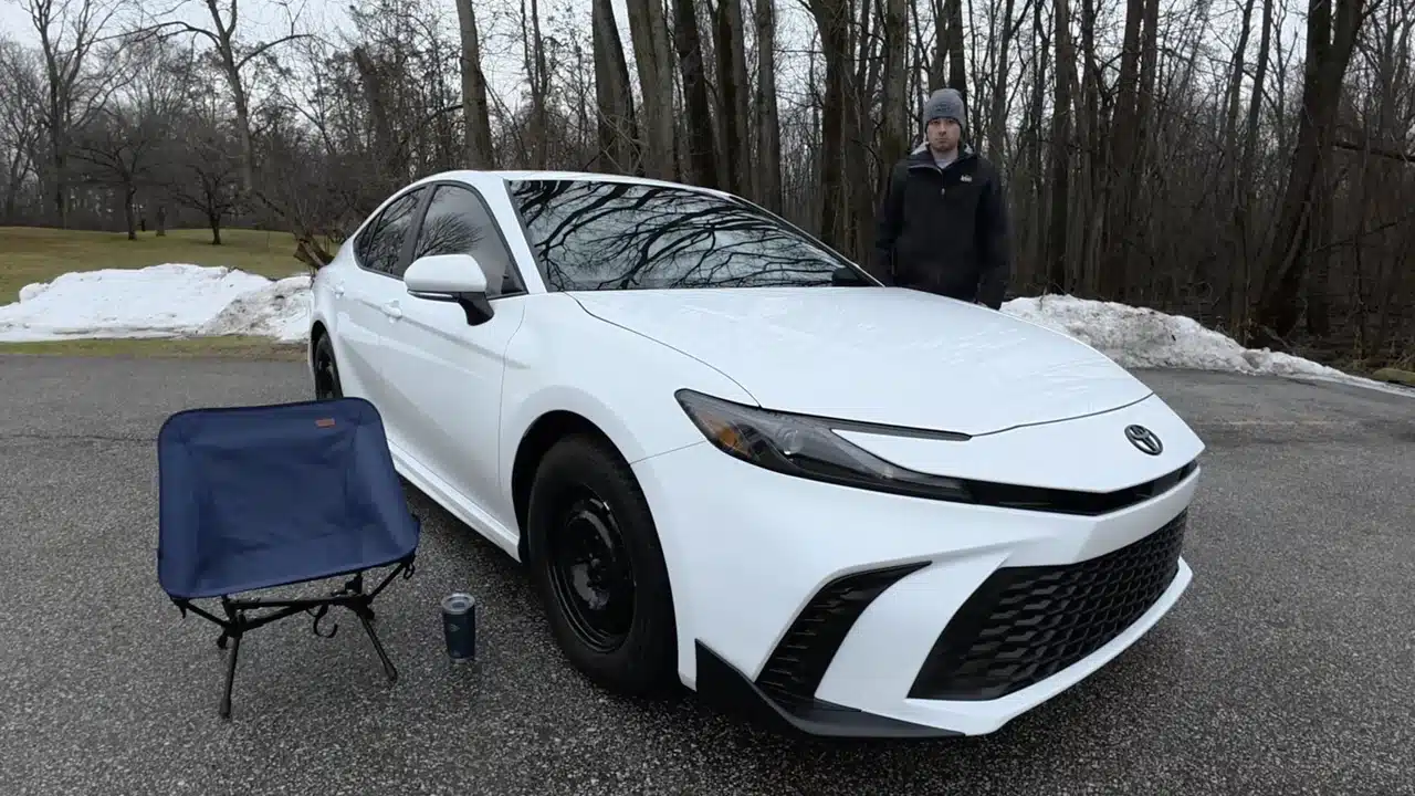 White 2025 Toyota Camry with its owner outdoors