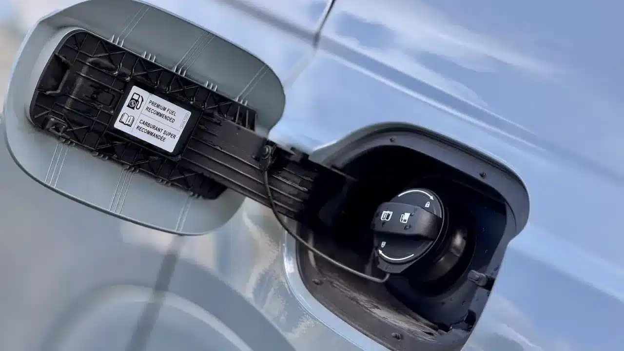 Open Genesis GV80 Coupe fuel door with premium fuel recommendation