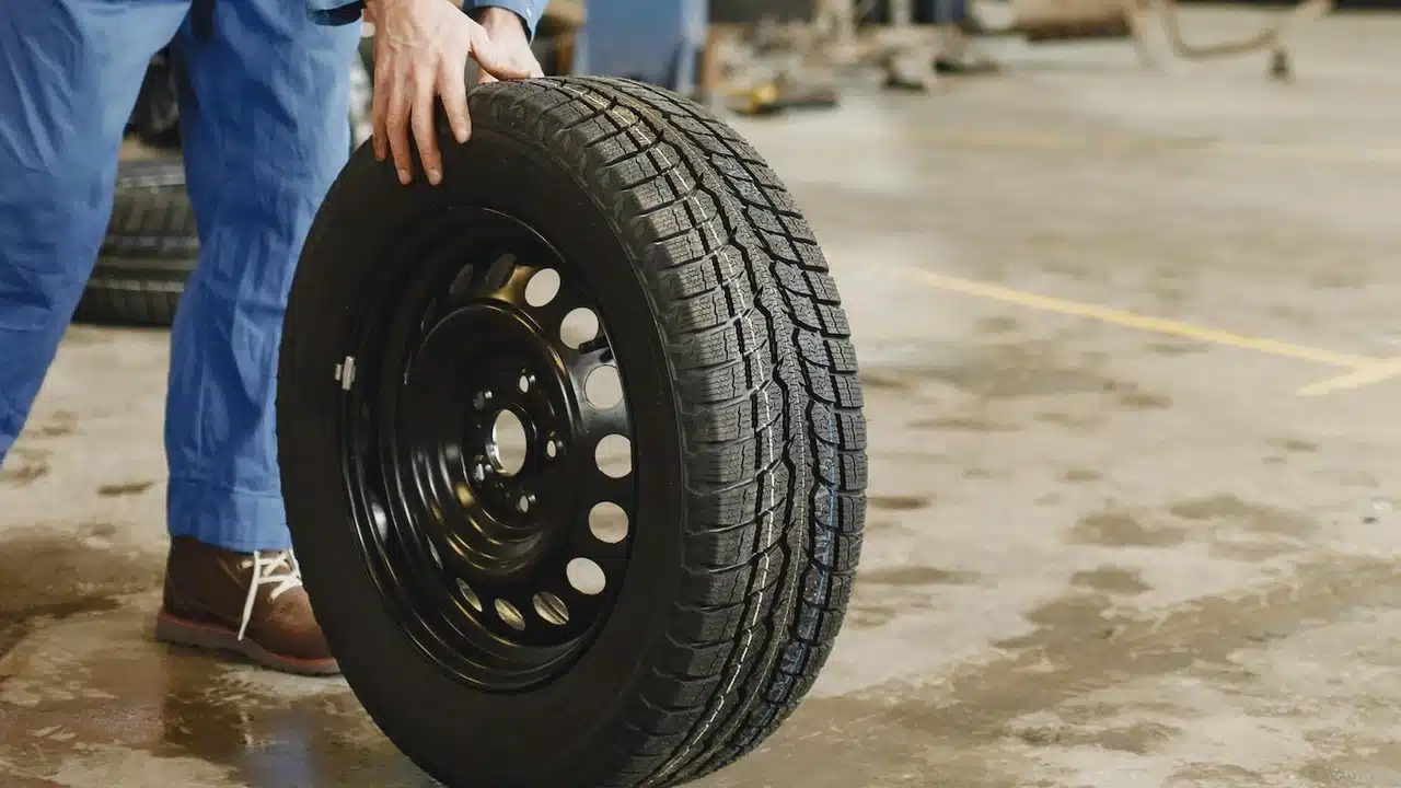 Mechanic holding a wheel and tire
