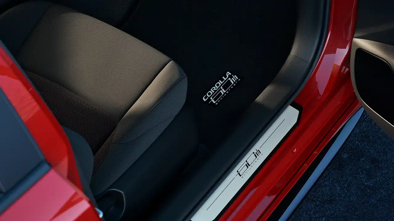 Black and red seat trim, anniversary floor mat and door sill in the 2027 Corolla