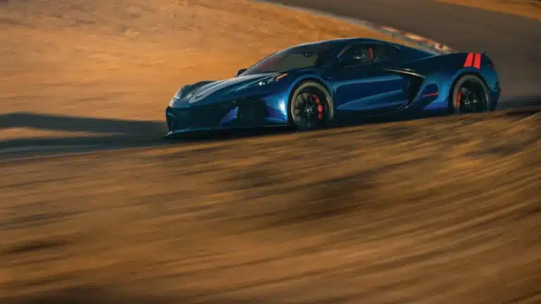 Blue 2027 Chevrolet Corvette Grand Sport driving on a road