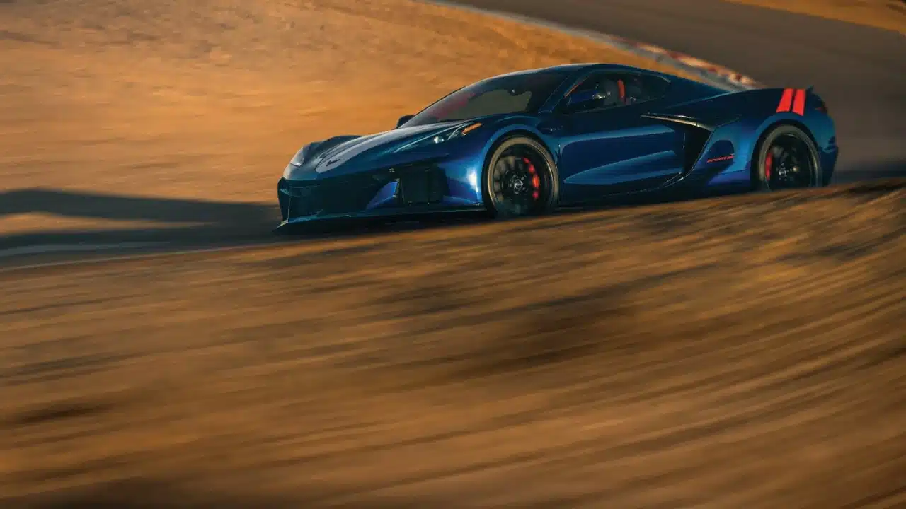 Blue 2027 Chevrolet Corvette Grand Sport driving on a road