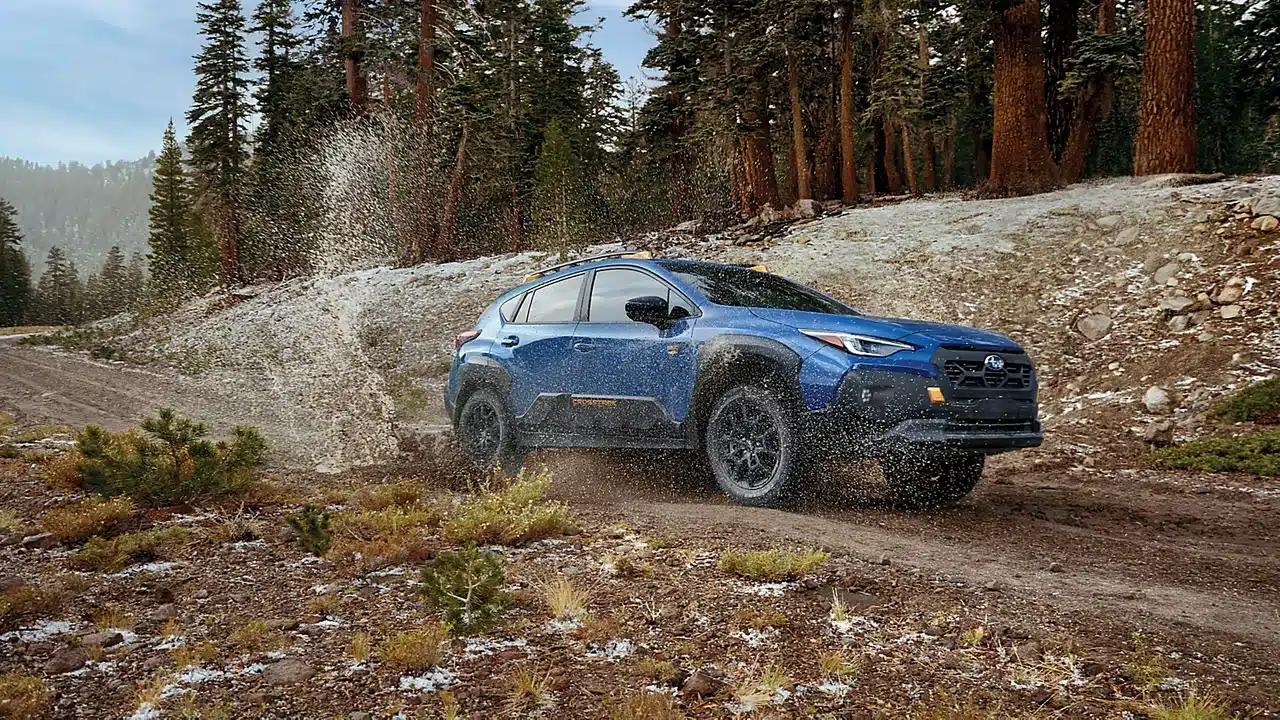 2026 Subaru Crosstrek Wilderness driving on a dirt trail