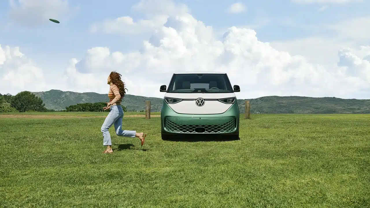 Green and white 2025 Volkswagen ID. Buzz in a field