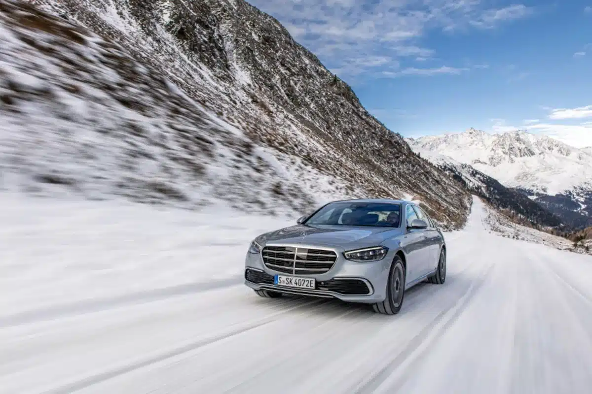 A silver Mercedes-Benz S 580 E on a snow-covered road
