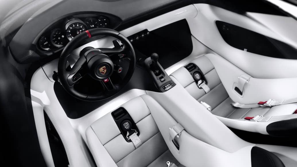 Porsche Mission S cabin with white seats, round gauges and physical dashboard controls